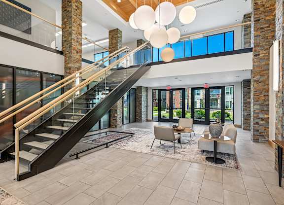 A modern interior with a staircase and a seating area.