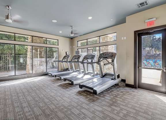 the preserve at ballantyne commons fitness room with cardio machines and windows