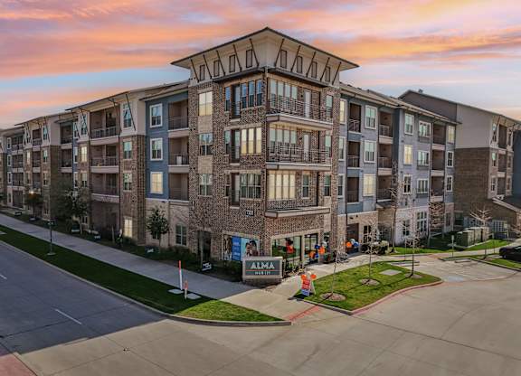 Apartment complex with a sign that says "ALMA".