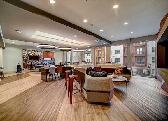 A living room with a stone wall and a fireplace.