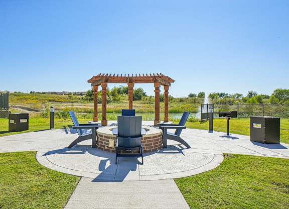A gazebo sits in the middle of a circular walkway with benches on either side.