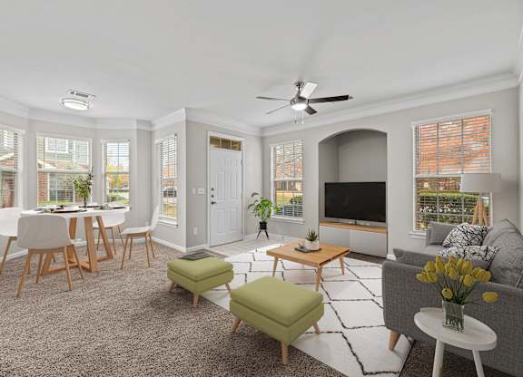 a living room with a couch and a table with chairs