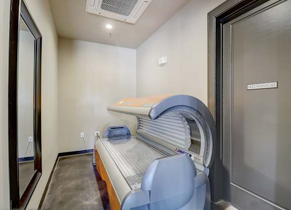 a patient room with an exam bed and an exam room door