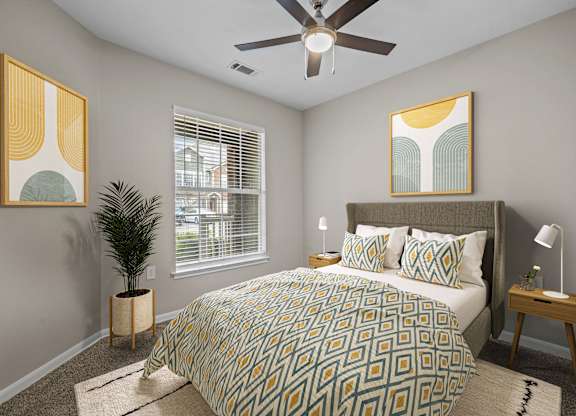 a bedroom with a large bed and a ceiling fan