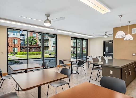 A modern kitchen and dining area with a view of the outside.