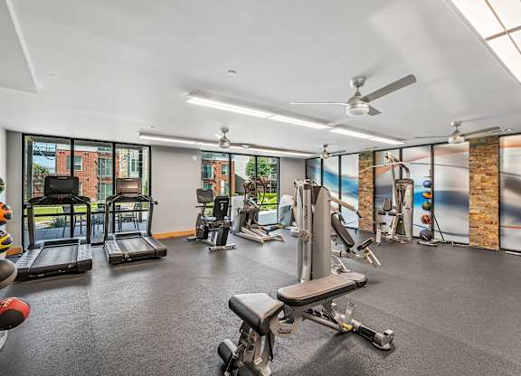 A spacious gym with a variety of equipment including treadmills, weights, and exercise machines.