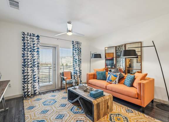 A living room with a sofa, a coffee table, and a rug.