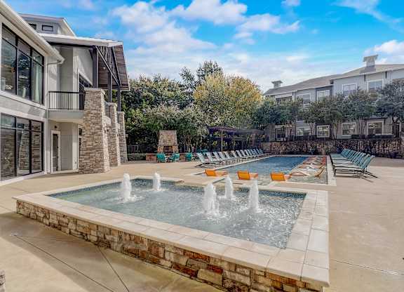 the preserve at ballantyne commons pool with water feature and lounge chairs
