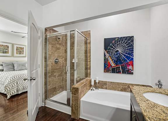 A bathroom with a large tub and a painting on the wall.