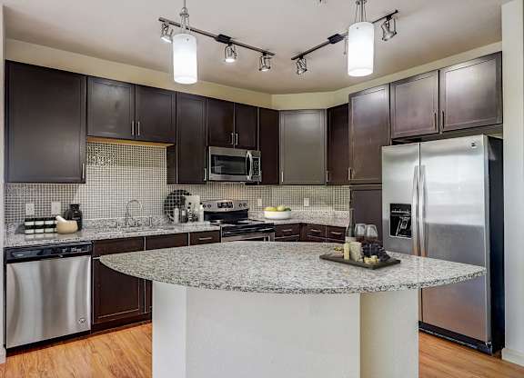 a kitchen with stainless steel appliances and granite counter tops