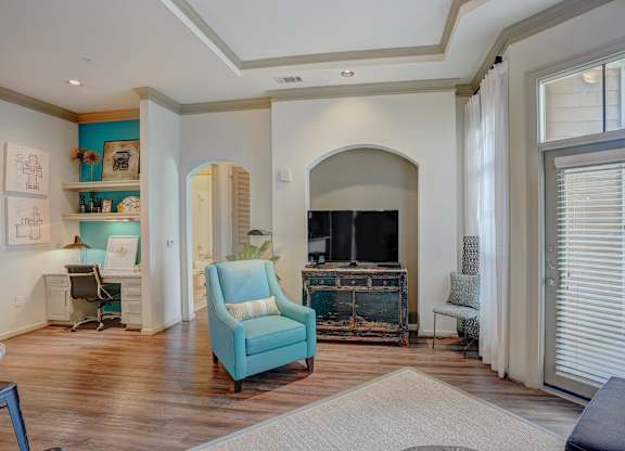 a living room with a fireplace and a blue chair