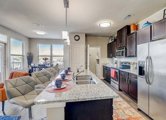 a kitchen with stainless steel appliances and a granite counter top