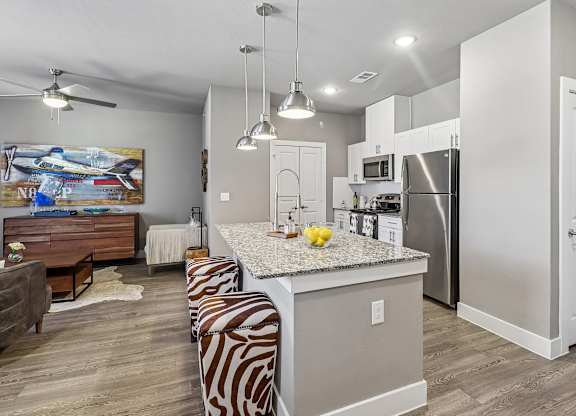 A kitchen with a zebra print bench in front of a counter.