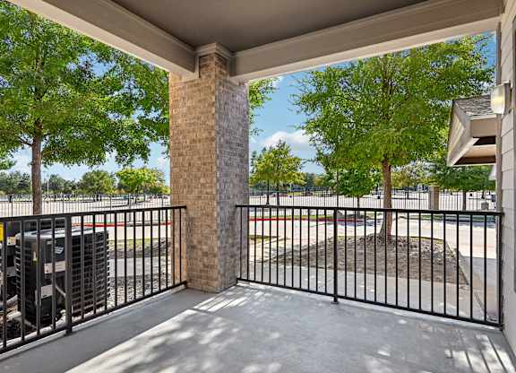 the preserve at ballantyne commons community balcony with metal fence and trees