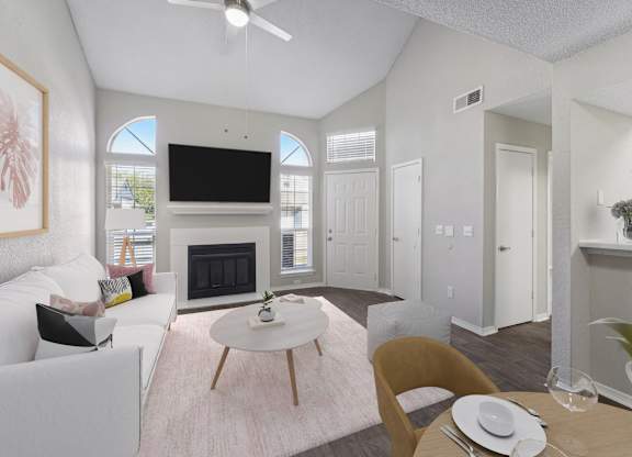 a living room with white furniture and a fireplace