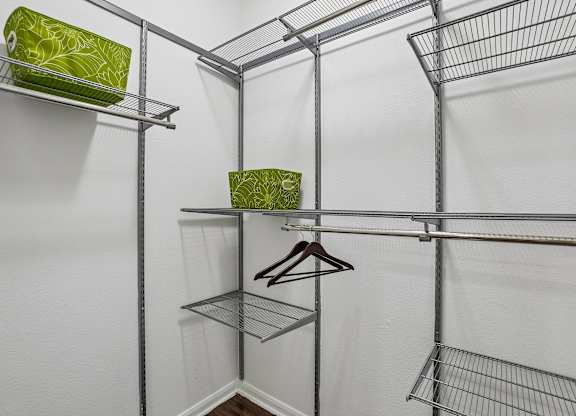 A white closet with a shelf and a hanger.