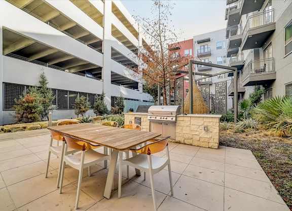A table and chairs are set up on a patio.