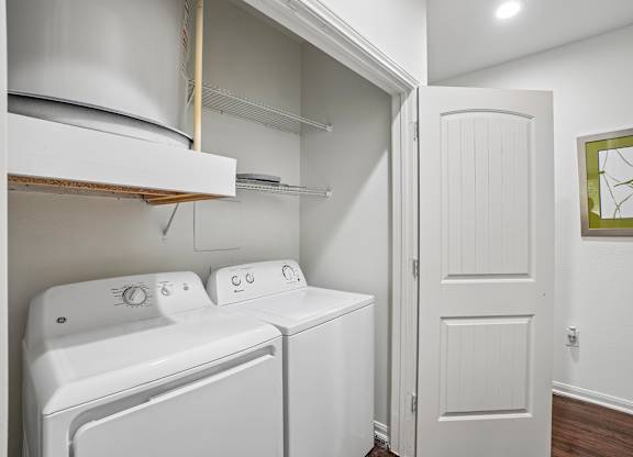 A white laundry room with a washer and dryer.