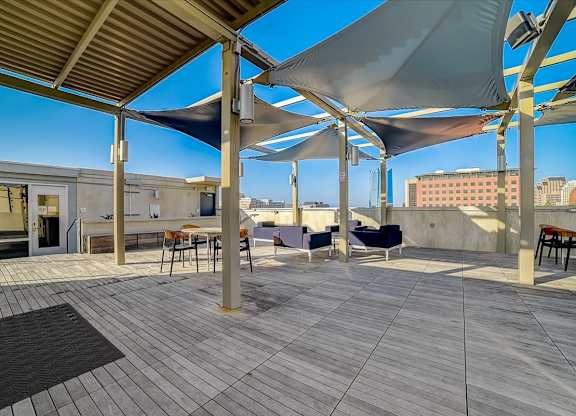 A patio with a table and chairs under a canopy.