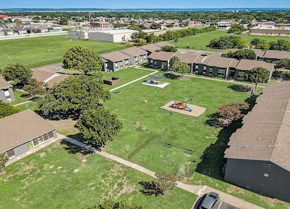 an aerial view of a backyard with a trampoline