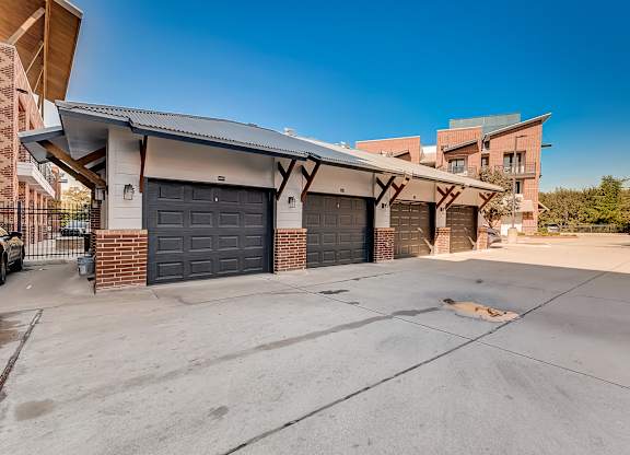 A house with a garage and a driveway in front of it.