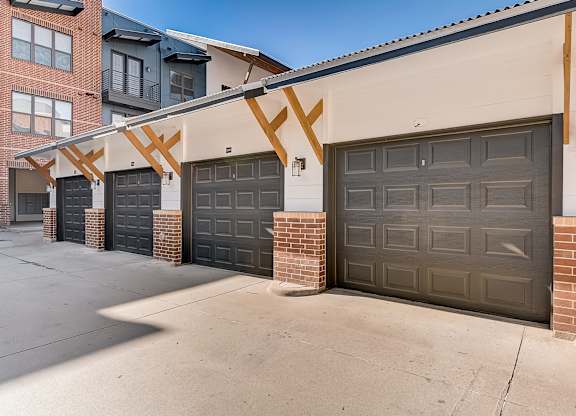 A row of garage doors in front of a building.