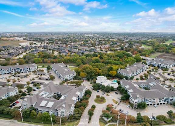 an aerial view of a neighborhood with houses and trees