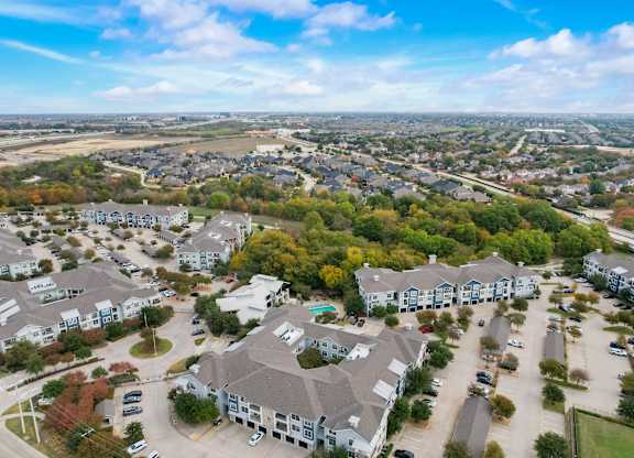 an aerial view of a neighborhood with houses and trees