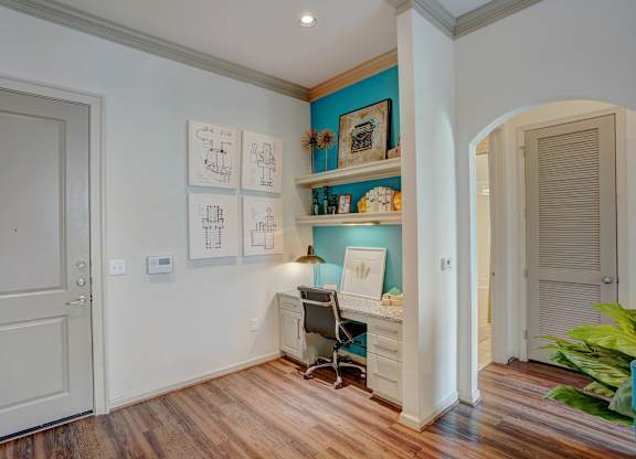 a home office with a desk and a chair