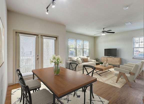 an open living room and dining room with a wooden table