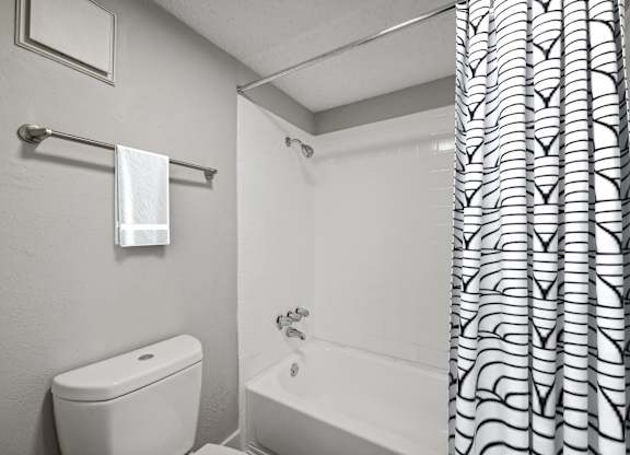 a bathroom with a shower curtain and a toilet