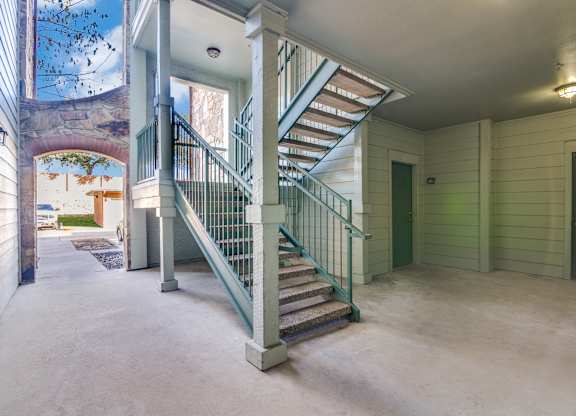 a spiral staircase on the second floor of a house with a door