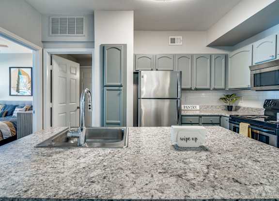 a kitchen with stainless steel appliances and granite counter tops