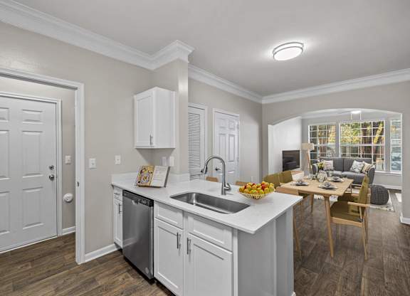 a kitchen and living room with a sink and a table