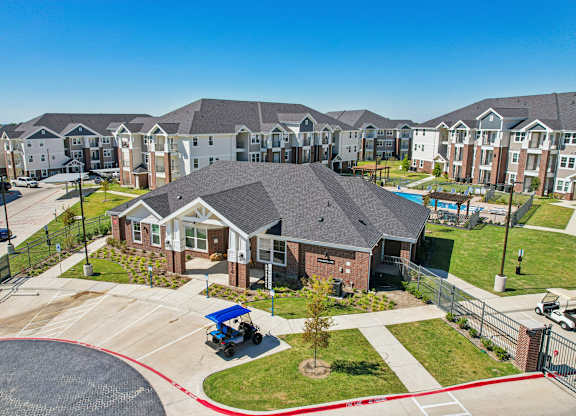 A residential area with houses and a blue lawnmower.