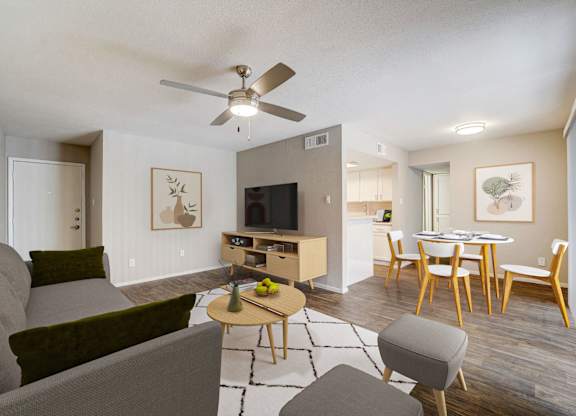 a living room with a ceiling fan and a dining room table