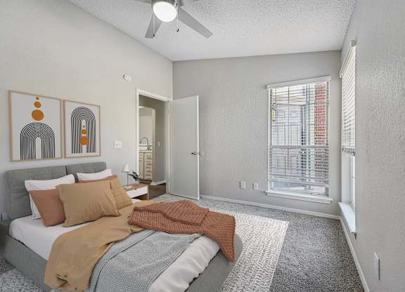 a bedroom with a bed and a ceiling fan