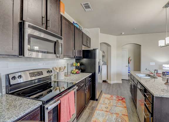 a kitchen with stainless steel appliances and granite counter tops