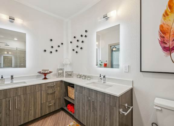 A bathroom with two sinks and a large mirror.