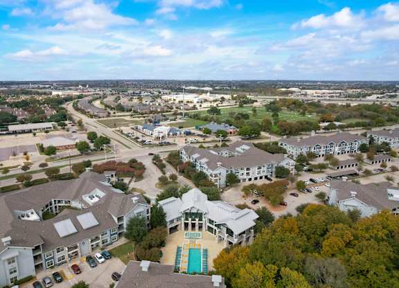 an aerial view of a neighborhood with houses and cars on the street