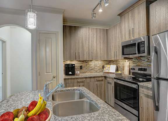 a kitchen with granite counter tops and stainless steel appliances
