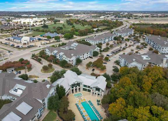 an aerial view of a neighborhood with houses and a swimming pool