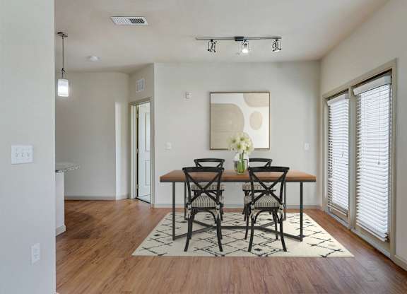 an empty living room with a dining room table and chairs
