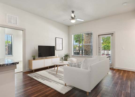 an open living room with a couch and a tv