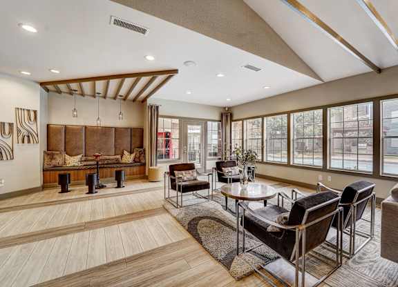 a living room with couches and chairs and a table