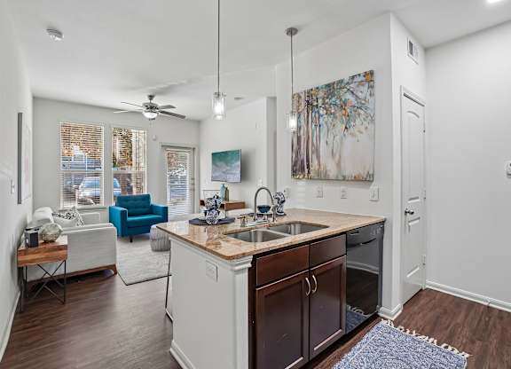 A kitchen with a white counter top and brown cabinets.