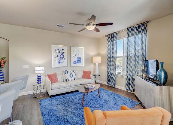 a living room with a blue rug and a couch