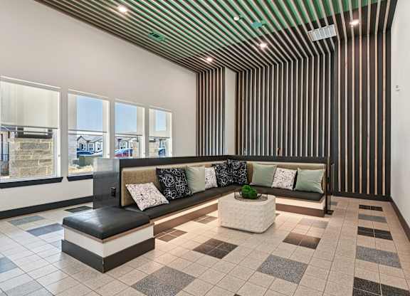 A long hallway with a bench and pillows.