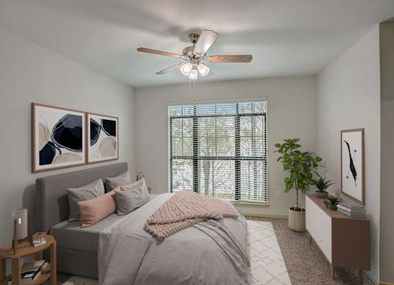 a bedroom with a large bed and a ceiling fan