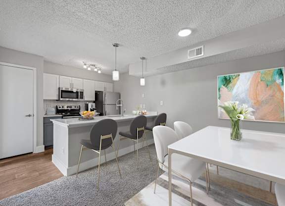 an open kitchen and dining room with a white table and chairs